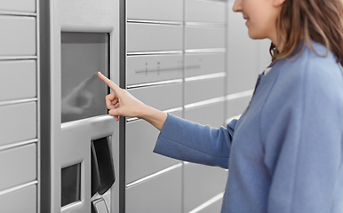 Image showing smiling woman using automated parcel machine