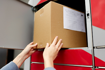 Image showing woman putting box to automated parcel machine