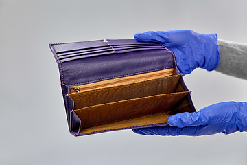 Image showing close up of hands in gloves with empty wallet