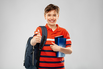 Image showing student boy with bag and books showing thumbs up