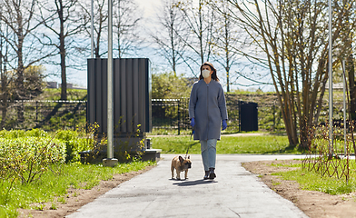 Image showing woman in mask and gloves with dog walking in city