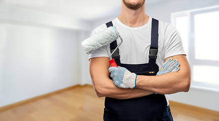 Image showing close up of painter or builder with paint roller