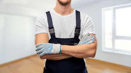 Image showing close up of male builder in overall and gloves