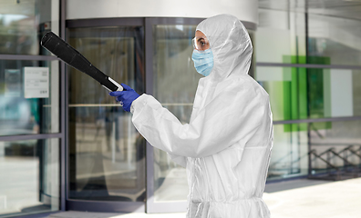 Image showing sanitation worker in hazmat with pressure washer