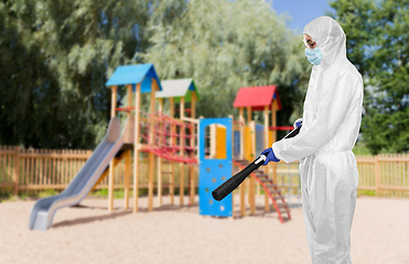 Image showing sanitation worker in hazmat with pressure washer