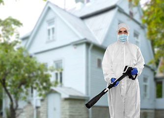 Image showing sanitation worker in hazmat with pressure washer