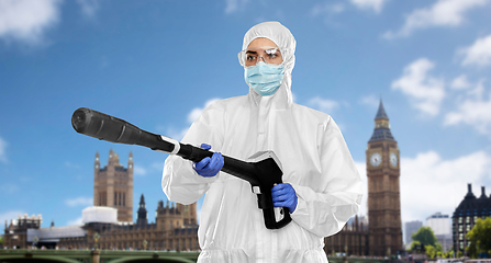 Image showing sanitation worker in hazmat with pressure washer