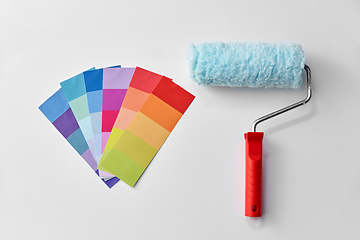 Image showing paint roller and color palette on white background