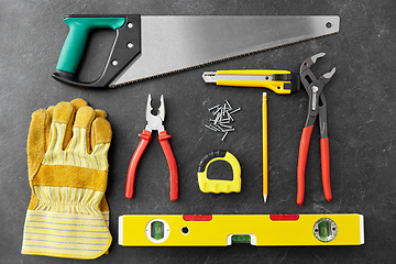 Image showing different work tools on slate background