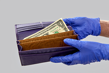 Image showing close up of hands in gloves with empty wallet
