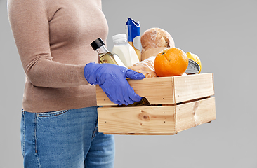 Image showing woman in gloves with food in wooden box