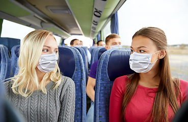 Image showing young women passengers in masks in travel bus