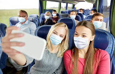 Image showing women taking selfie by smartphone in travel bus