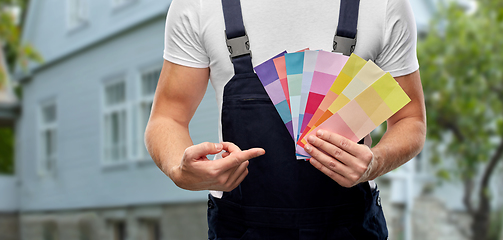 Image showing close up of painter with color charts