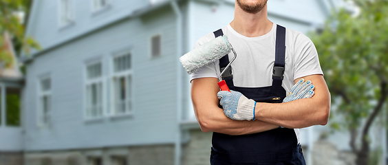 Image showing close up of painter or builder with paint roller