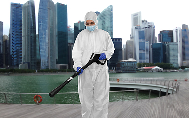 Image showing sanitation worker in hazmat with pressure washer