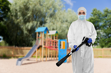 Image showing sanitation worker in hazmat with pressure washer