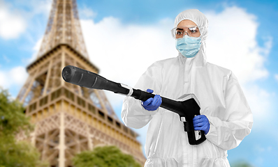 Image showing sanitation worker in hazmat with pressure washer