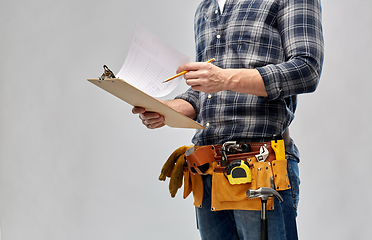 Image showing builder with clipboard, pencil and working tools