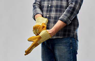 Image showing man or builder putting protective gloves on