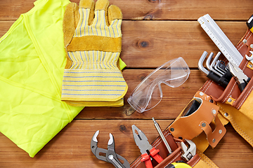 Image showing different work tools in belt on wooden boards