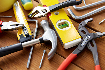 Image showing different work tools on wooden boards background