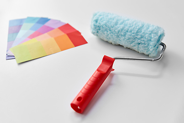 Image showing paint roller and color palette on white background