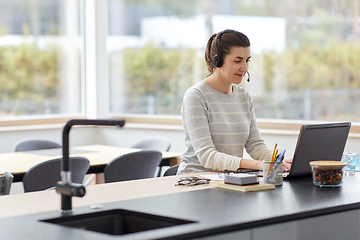 Image showing woman with headset and laptop working at home