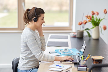 Image showing woman with headset and laptop working at home