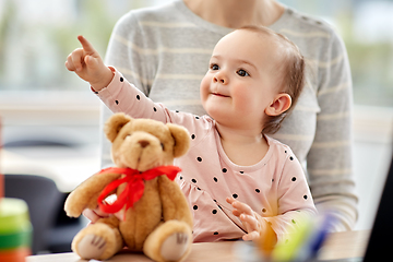 Image showing happy baby with mother working at home office