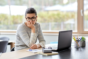 Image showing bored woman with laptop working at home office