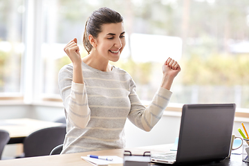 Image showing happy woman with laptop working at home office