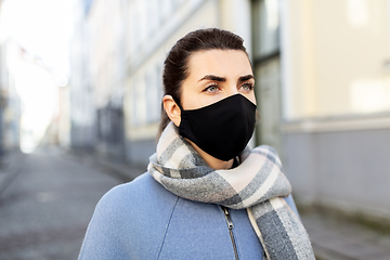 Image showing woman wearing protective reusable mask in city