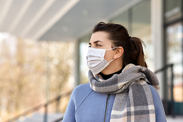 Image showing young woman wearing protective medical mask