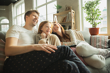 Image showing Family spending nice time together at home, looks happy and cheerful, eating pizza