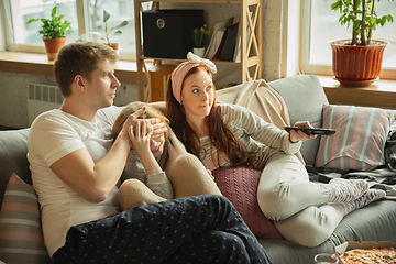 Image showing Family spending nice time together at home, looks happy and cheerful, eating pizza