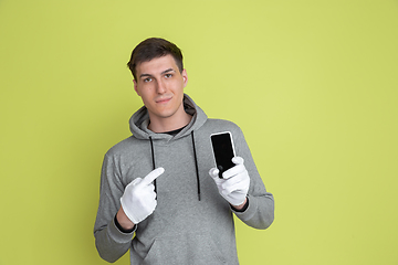 Image showing Caucasian man\'s portrait isolated on yellow studio background - freaky model