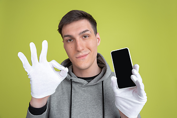 Image showing Caucasian man\'s portrait isolated on yellow studio background - freaky model