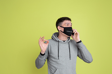 Image showing Caucasian man\'s portrait isolated on yellow studio background - freaky model