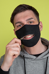 Image showing Caucasian man\'s portrait isolated on yellow studio background - freaky model