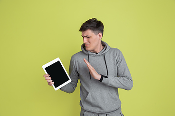 Image showing Caucasian man\'s portrait isolated on yellow studio background - freaky model