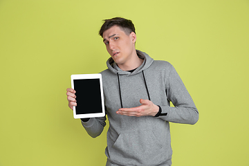 Image showing Caucasian man\'s portrait isolated on yellow studio background - freaky model