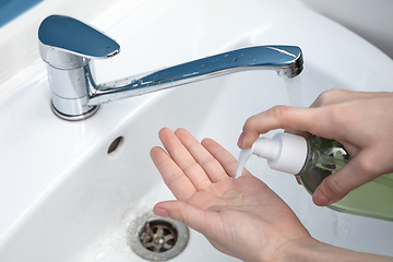 Image showing Woman washing hands carefully in bathroom close up. Prevention of infection and pneumonia virus spreading