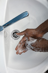 Image showing Man washing hands carefully in bathroom close up. Prevention of infection and pneumonia virus spreading