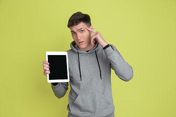 Image showing Caucasian man\'s portrait isolated on yellow studio background - freaky model