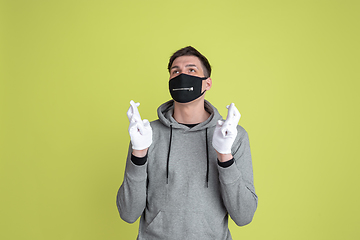 Image showing Caucasian man\'s portrait isolated on yellow studio background - freaky model