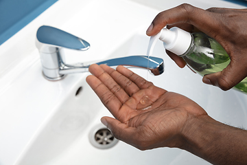 Image showing Man washing hands carefully in bathroom close up. Prevention of infection and pneumonia virus spreading