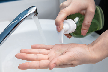 Image showing Woman washing hands carefully in bathroom close up. Prevention of infection and pneumonia virus spreading