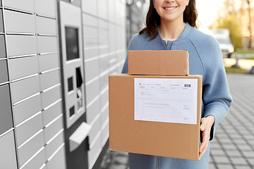 Image showing woman with boxes at automated parcel machine