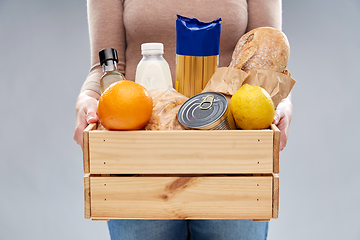 Image showing close up of woman with food in wooden box